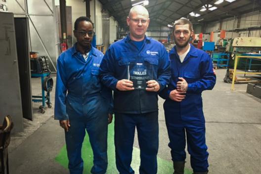 Amcanu workers holding the Made in Wales award