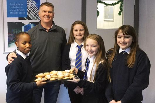 Laura, Bradley, Josi and Emily from Glan-y-mor school give a tray of mince pies to Owain Davies.