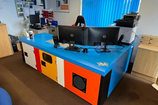 A desk in multiple colours, that looks like enclosures.